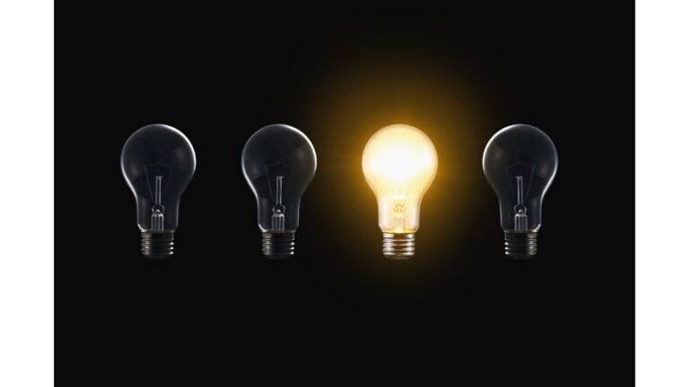 One illuminated lightbulb among dark bulbs representing mental clarity and focus emerging from mental clutter