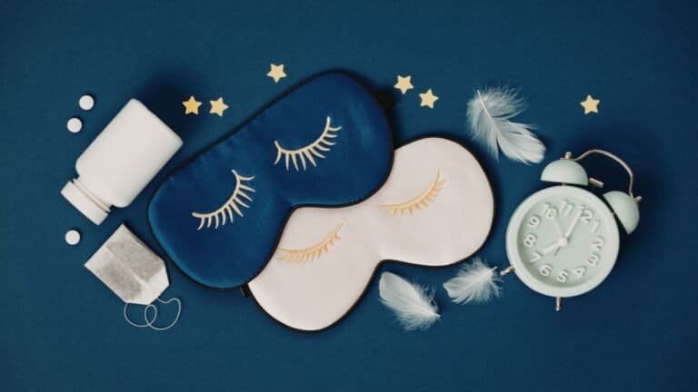 Sleep quality essentials including eye masks, earplugs, and alarm clock arranged on blue background