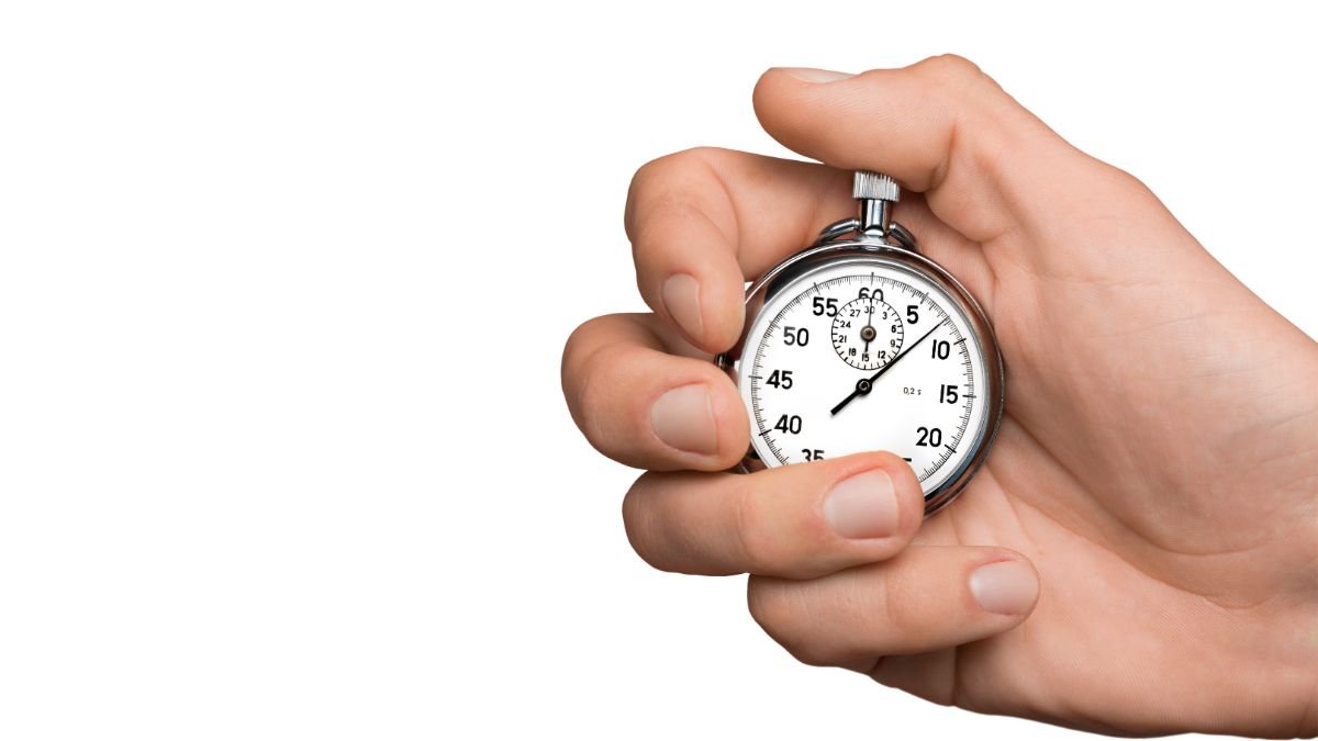 Hand holding stopwatch representing the two-minute rule for building habits effectively