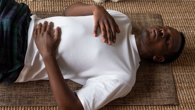 person using breathing exercises as a brief stress management technique
