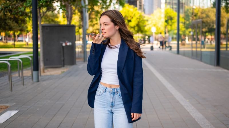 Person using voice memo app on smartphone to capture ideas while walking