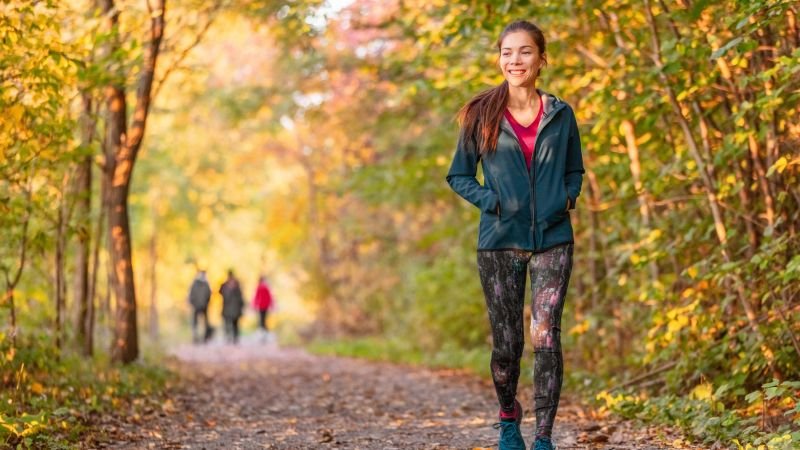 Woman starting gently with exercise by taking a walk in the park
