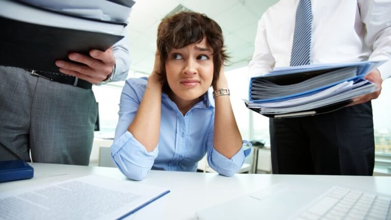Lady being giving tasks by others, who needs to learn how to say no at work