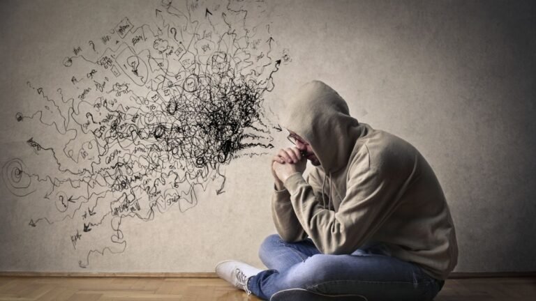 Man sitting cross-legged, experiencing negative thoughts, illustrating overthinking