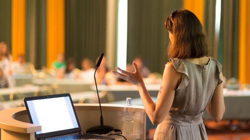 Lady presenting confidently at a podium without anxiety