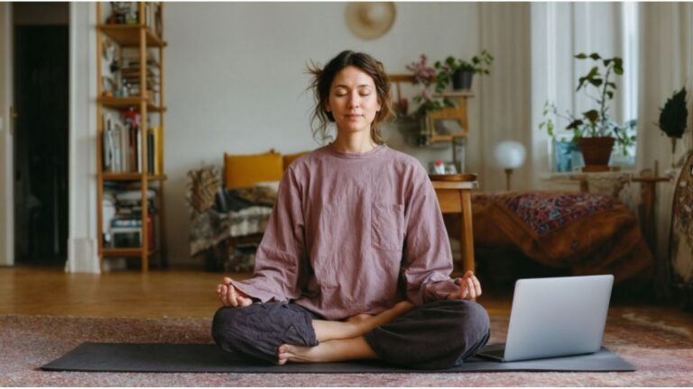 Woman practicing meditation at home to manage stress and improve mental performance