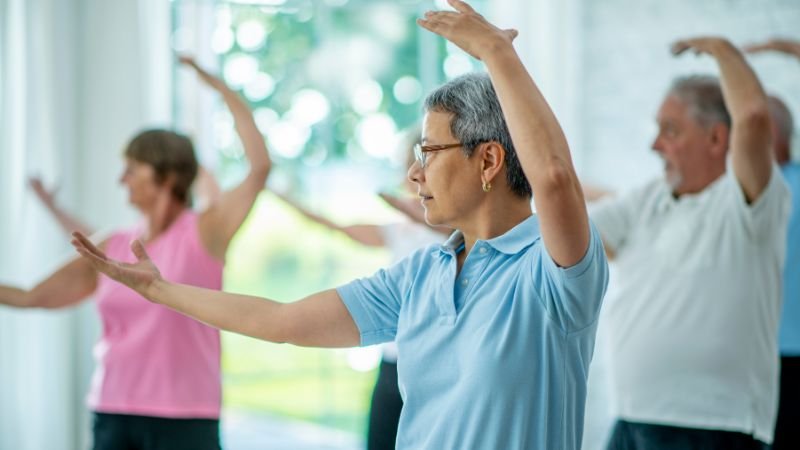 People practising tai chi — one of the best exercises for brain health for those with physical limitations