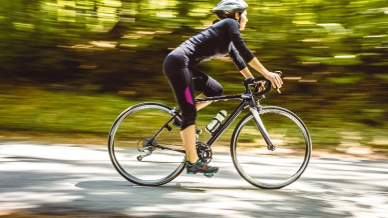 Person cycling outdoors — aerobic exercise is considered the best exercise for brain health due to its robust cognitive benefits